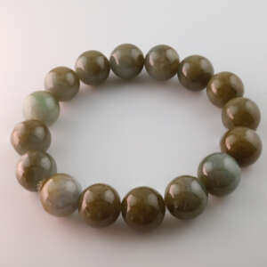 Top view of Burmese jadeite beaded bracelet featuring uniform 13.4 mm natural A-type jadeite beads with subtle gradient from grey-green to moss tones, fine polish, and natural sheen.