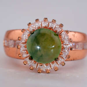 Front view of Burmese jade cabochon ring showing green jade center, halo of baguette stones, and rose-gold band, size 8