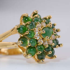 Angled side view of A-Type jadeite green cabochon flower ring in yellow-gold tone setting