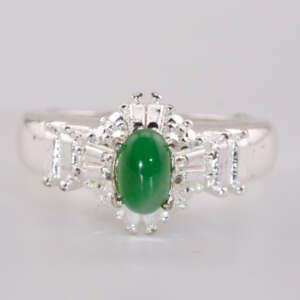 Front view of a vivid green oval jadeite cabochon ring set in polished silver with decorative accent detailing